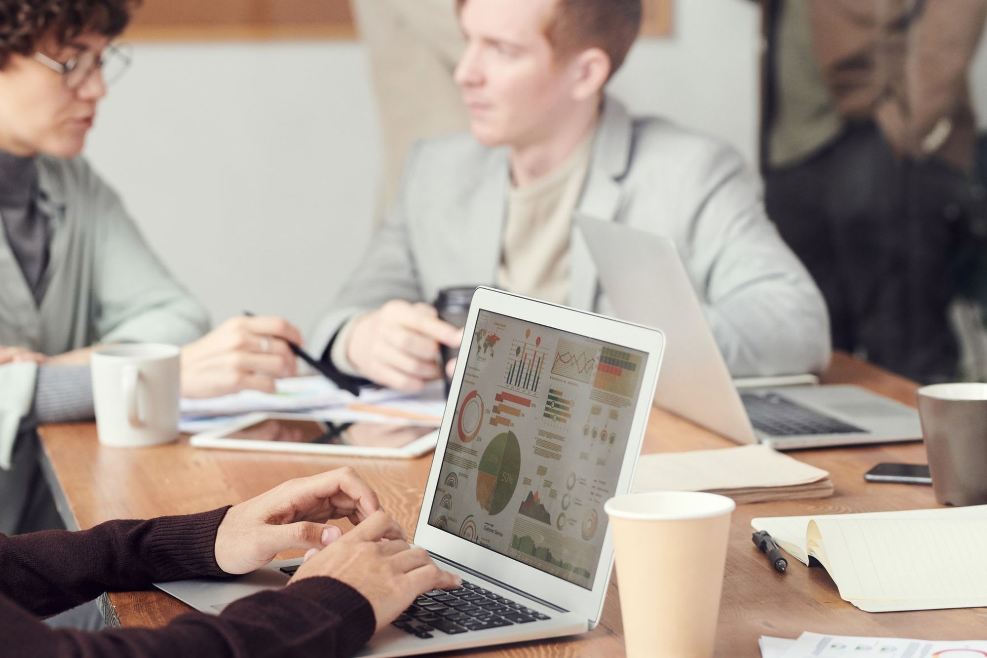 A team reviewing documents around a table, illustrating an AI governance policy review